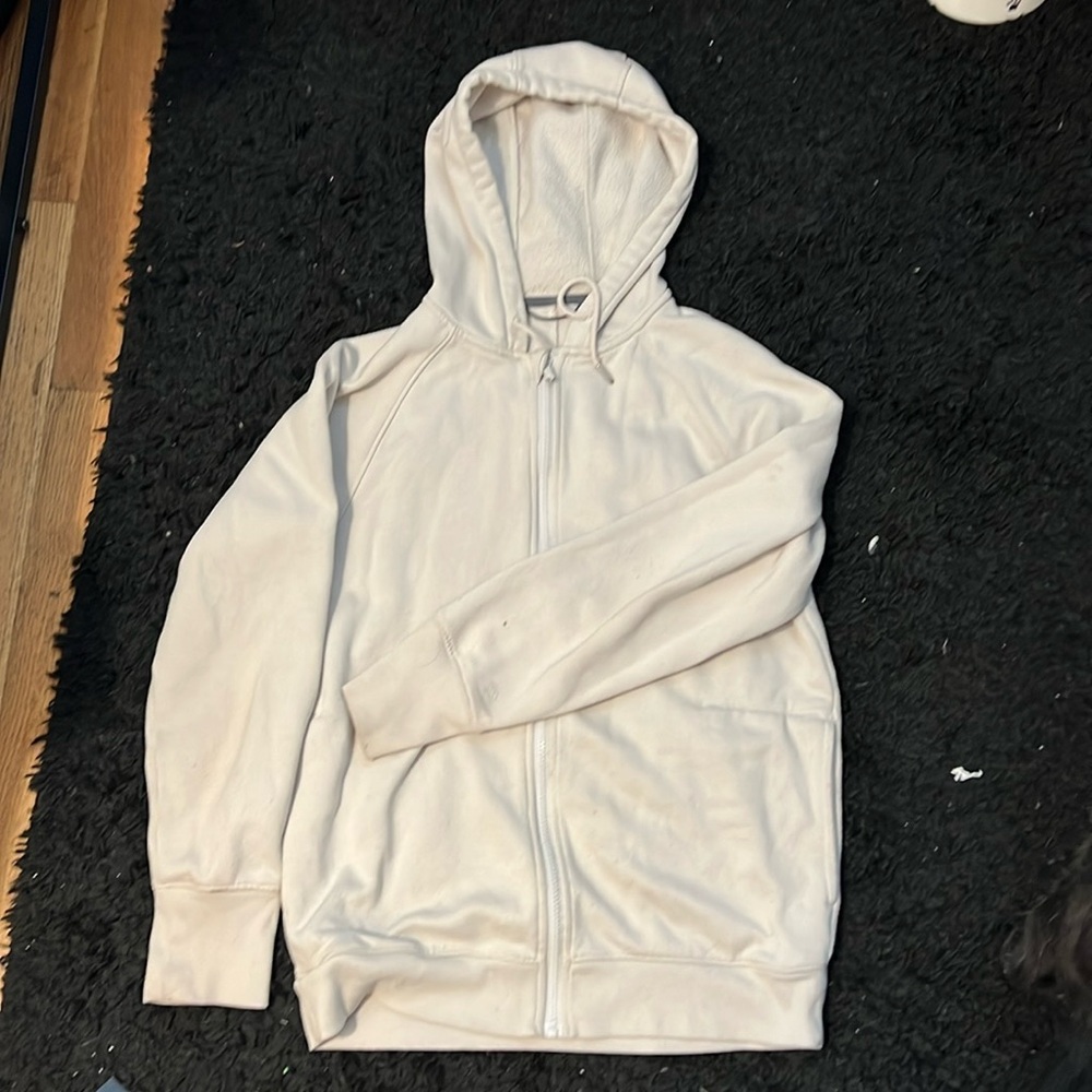 A women’s (all in motion brand) small cream colored zipper hoodie.